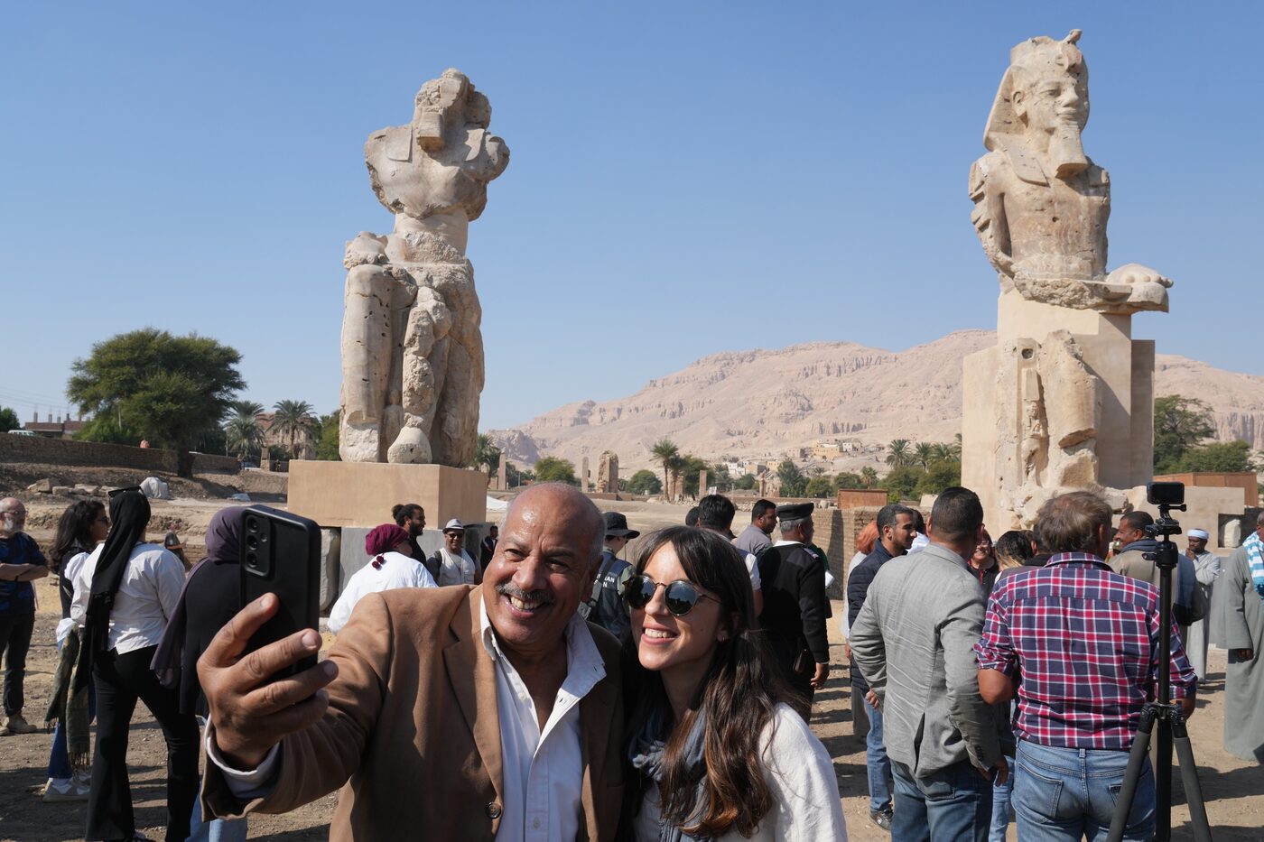 Visitors photograph the two giant reassembled alabaster statues of Pharaoh Amenhotep III in Luxor, Egypt, December 14, 2025.